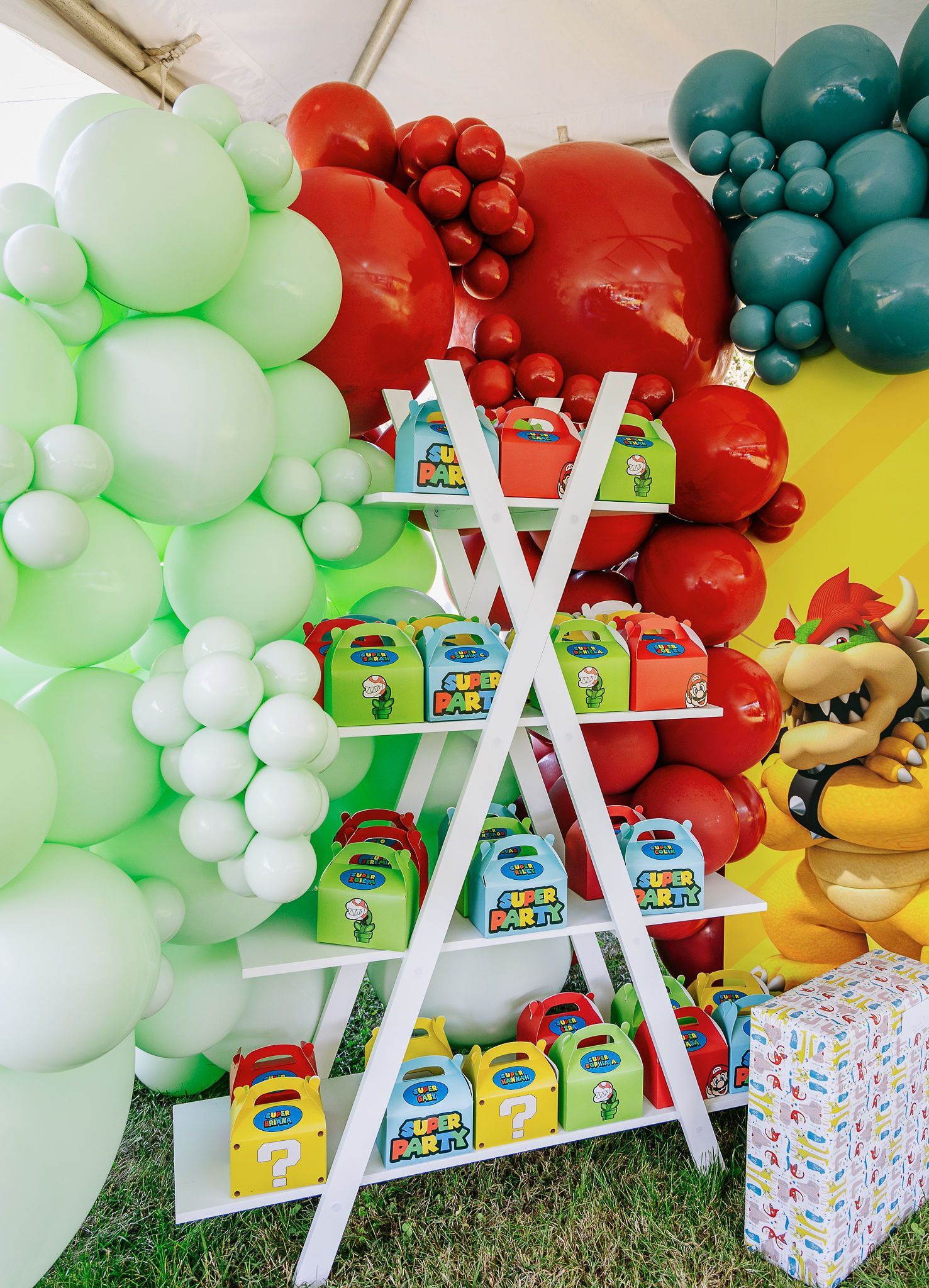 A ladder filled with candy and balloons at a birthday party.