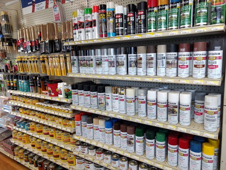 A store shelf filled with a variety of spray paints
