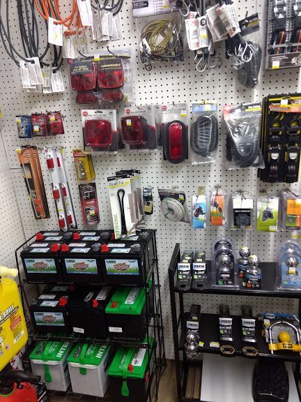 A bunch of batteries are sitting on a shelf in a store.