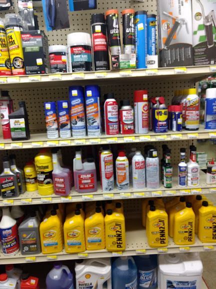 A store shelf filled with lots of cleaning supplies including wd-40