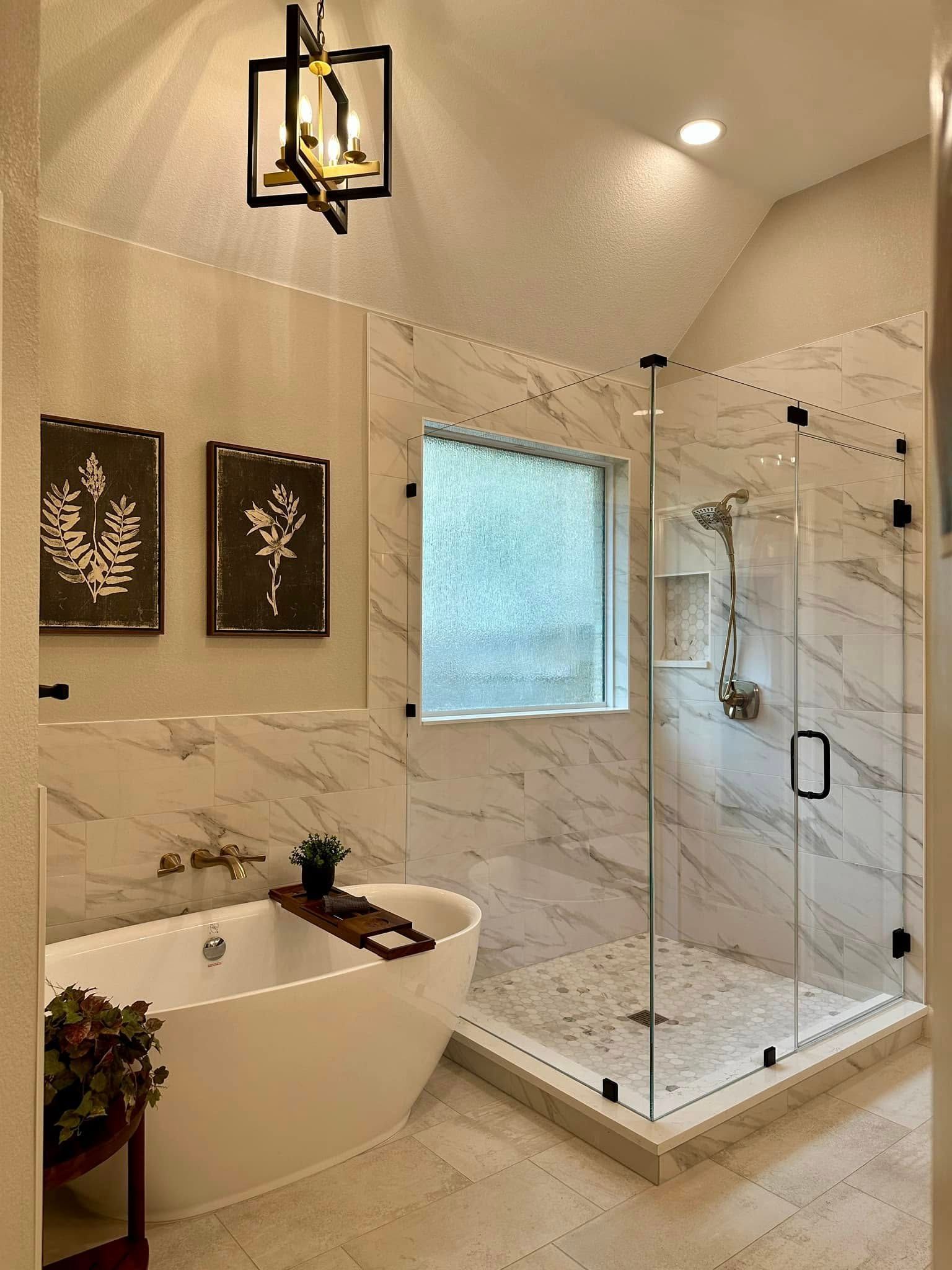 Modern marble bathroom with glass shower, freestanding tub, and soft ceiling lights