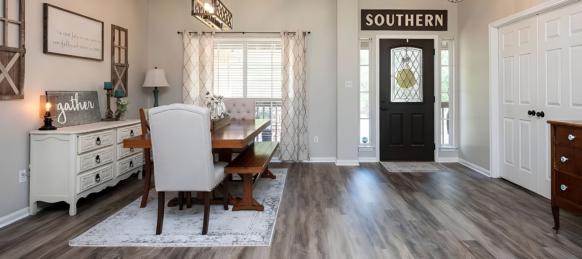 Bright home office with desk, white chairs, wood floors, and a door labeled “SOUTHERN”.