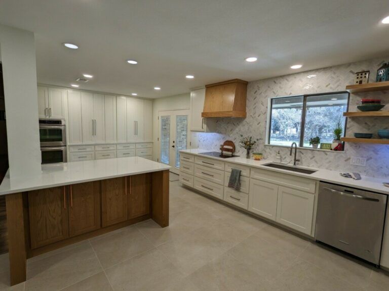 Modern bright kitchen with white cabinets, wood island, stainless appliances, and large window