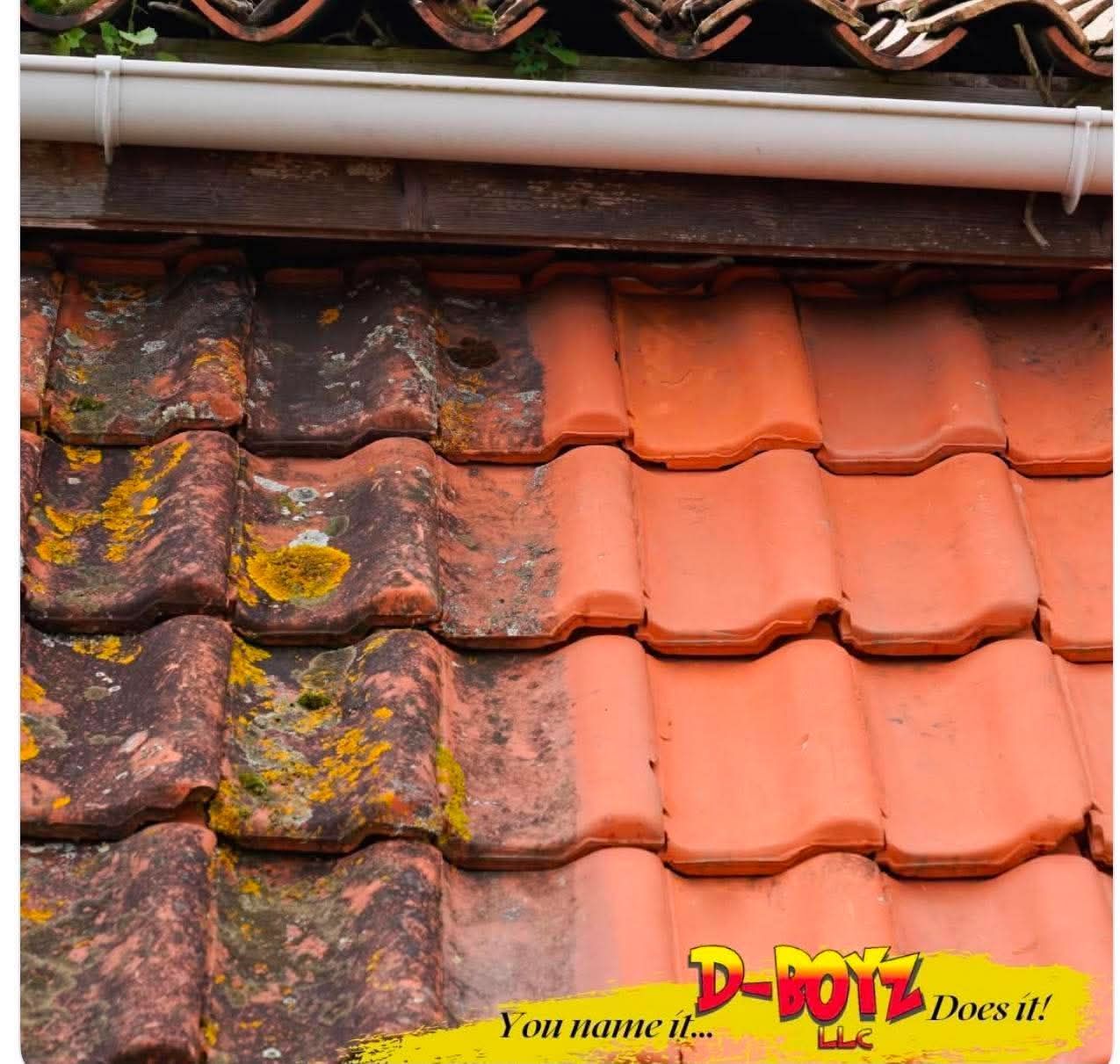 Close-up of weathered red clay roof tiles, some covered in moss, beside newer clean tiles.