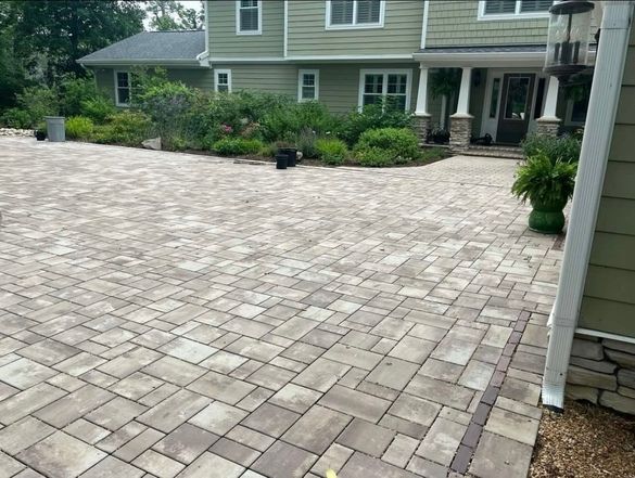 a large house with a brick driveway in front of it