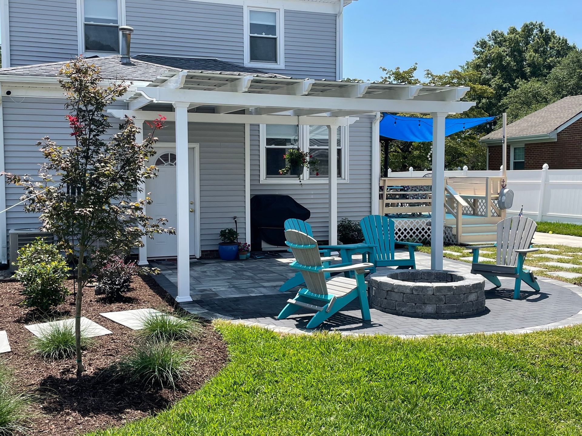 there is a fire pit in the backyard of a house