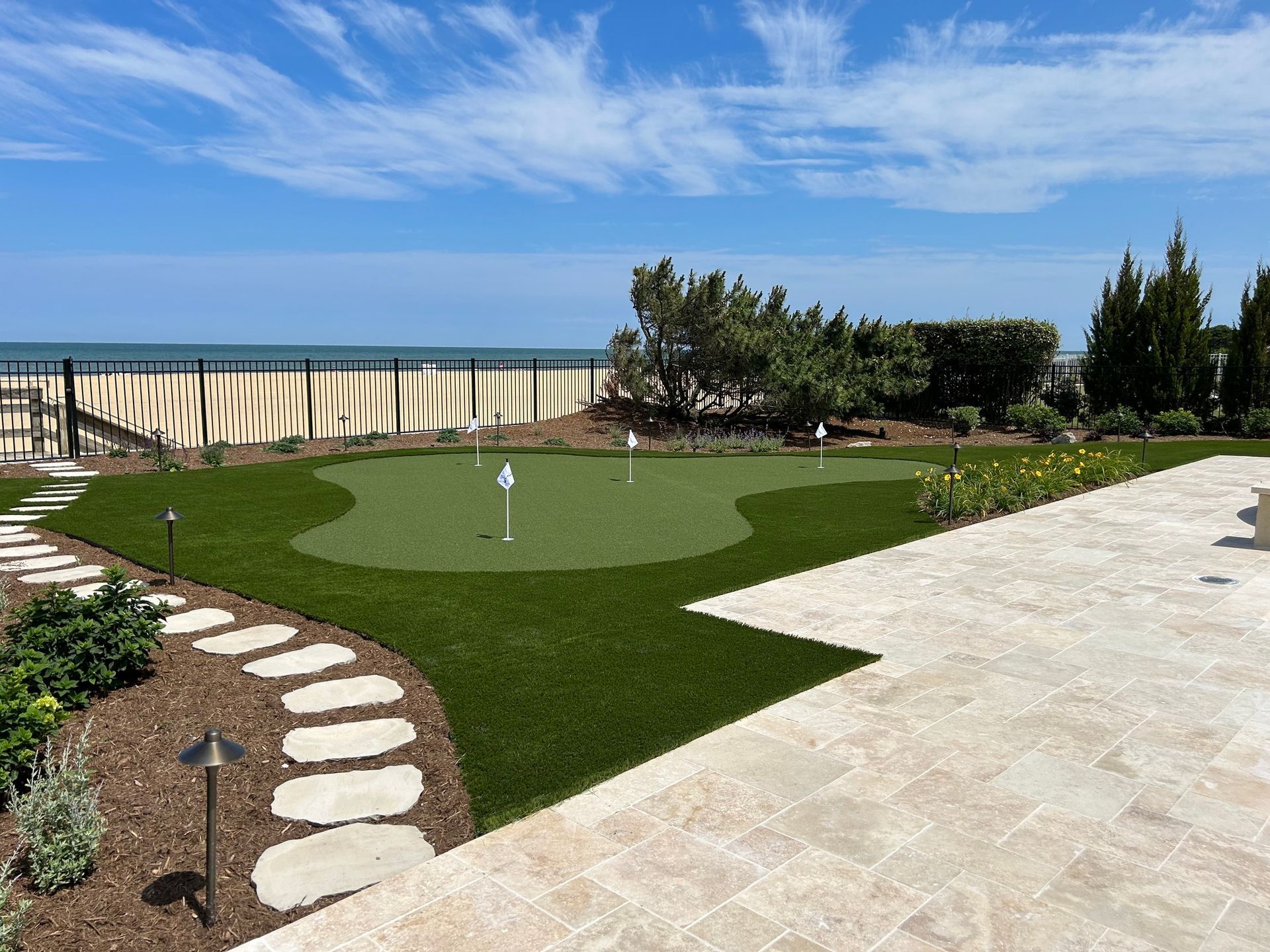 there is a putting green in the middle of a lush green field