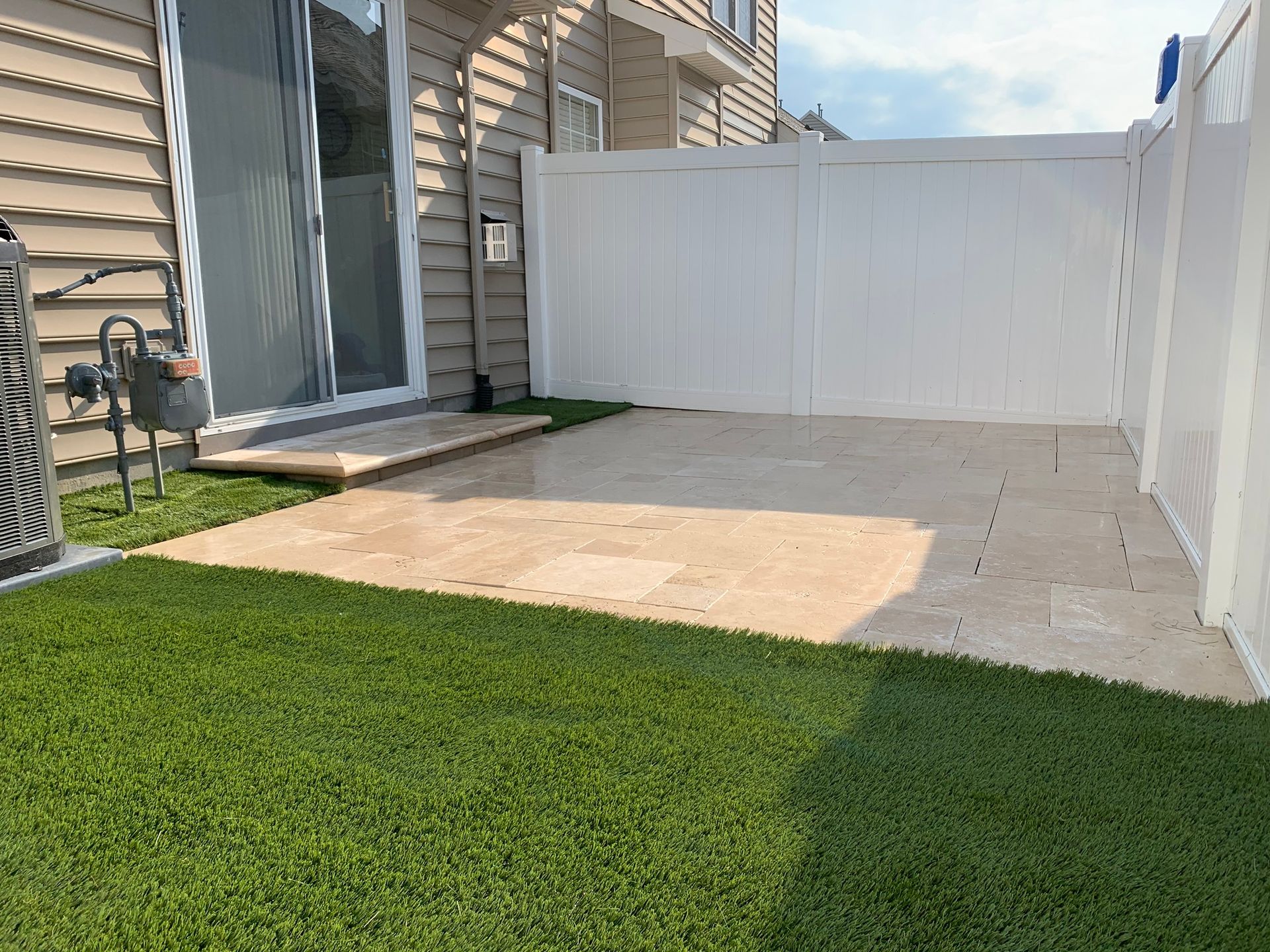 there is a white fence in the backyard of a house