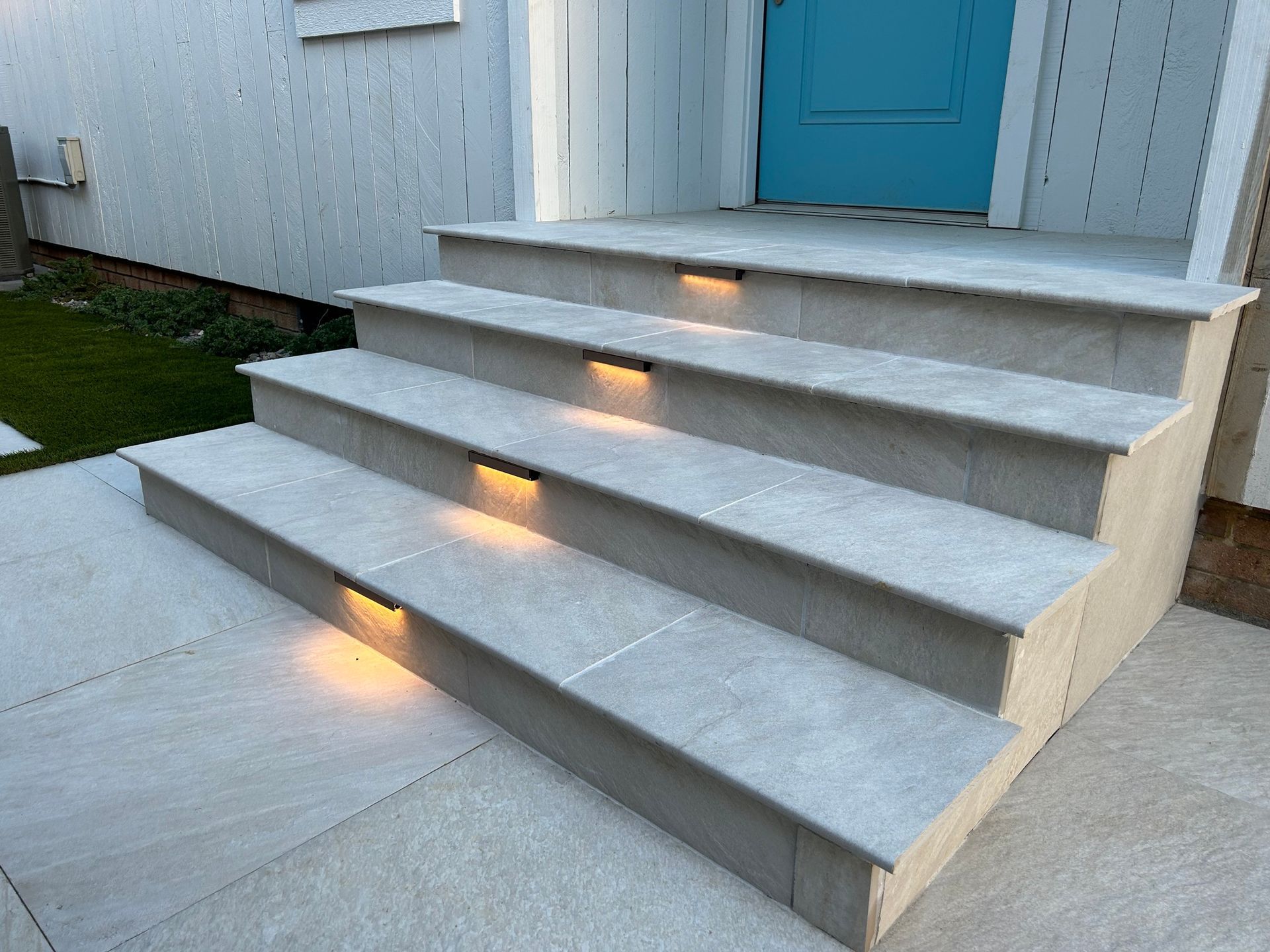 a set of stairs leading up to a blue door