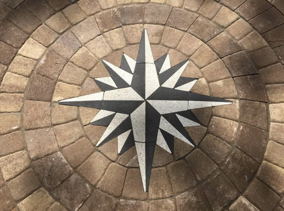 a compass rose is painted on a brick floor