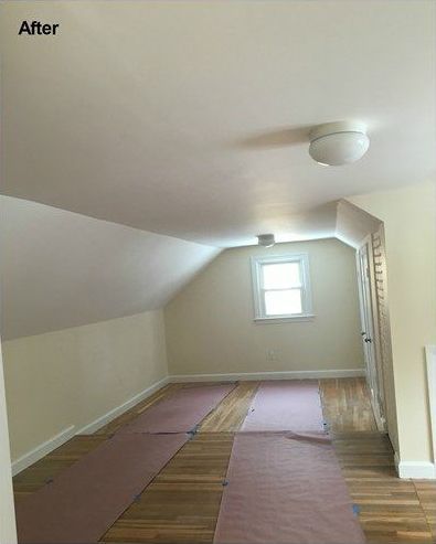 A room with a vaulted ceiling and a window.