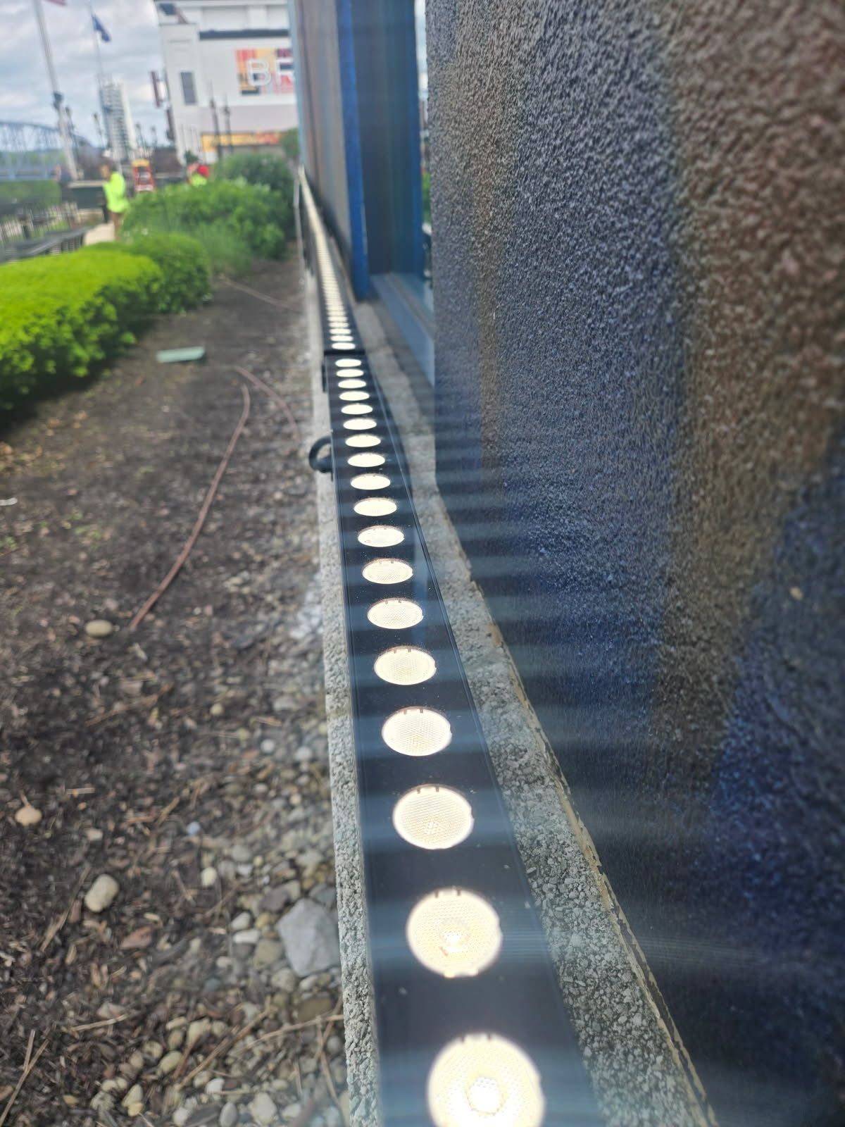 A row of lights on the side of a building.