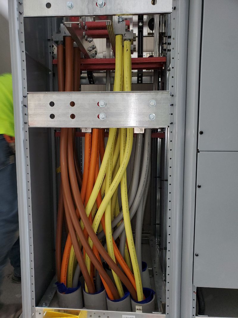 A bunch of electrical wires are coming out of a box