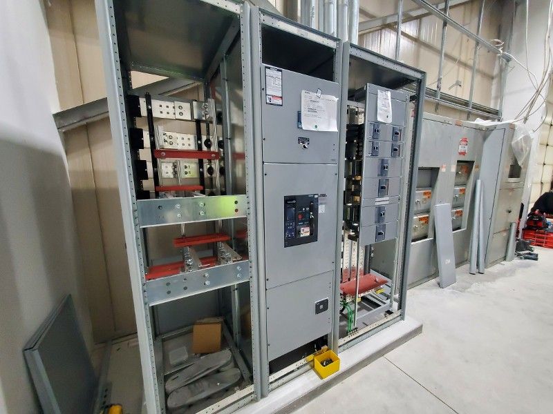 A bunch of electrical boxes are sitting next to each other in a room.