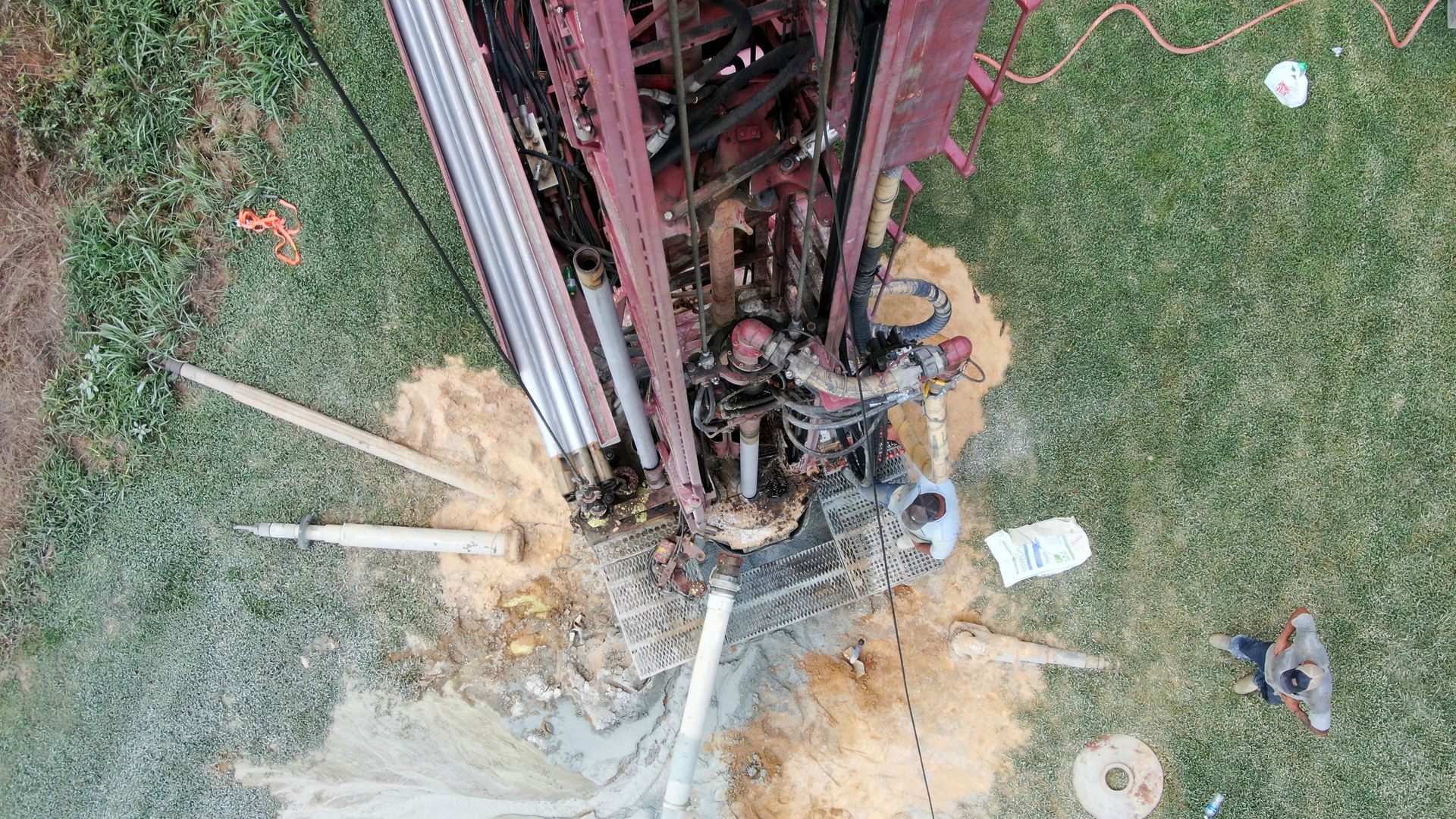 An aerial view of a water well being drilled in the ground.