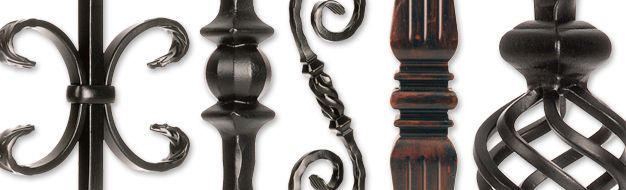 Close-up of various ornate iron balusters, showcasing different decorative designs and finishes.