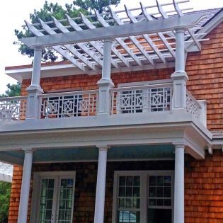 A house with a balcony and a pergola on top