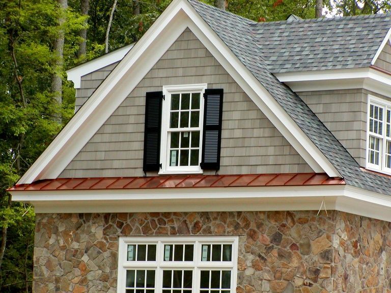 A house with a stone facade and a copper roof