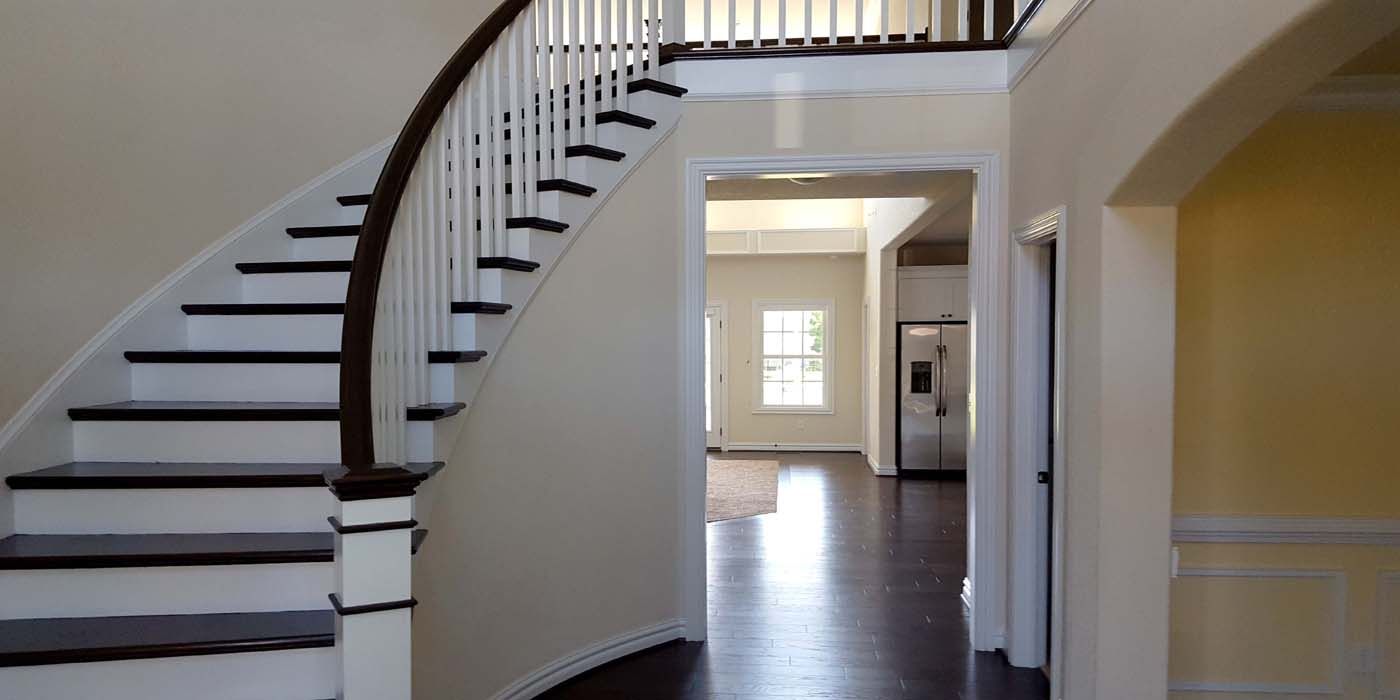 A curved staircase leading up to the second floor of a house