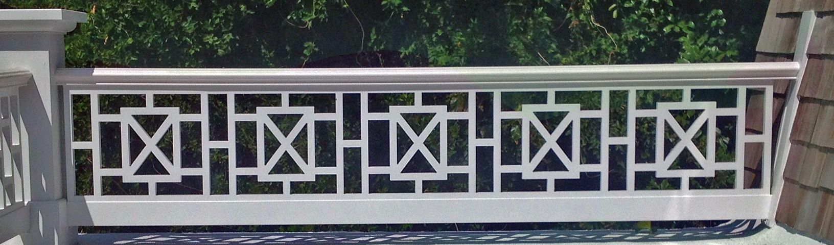 A white railing with a geometric pattern on it