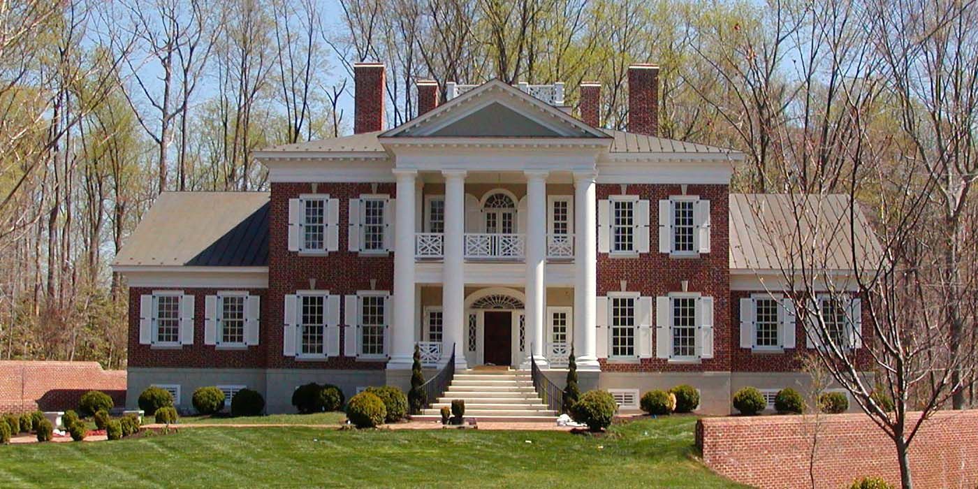 A large brick house with white trim and shutters