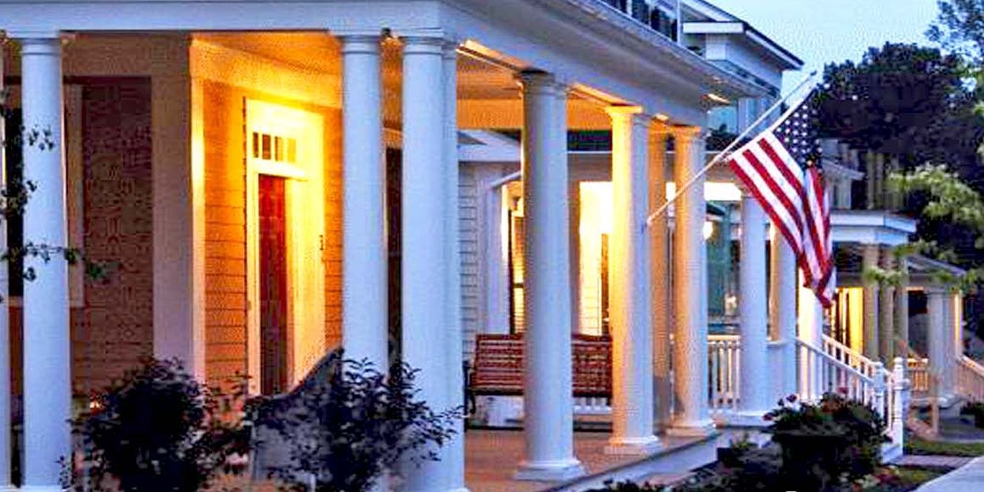 A house with a porch and an american flag on it.