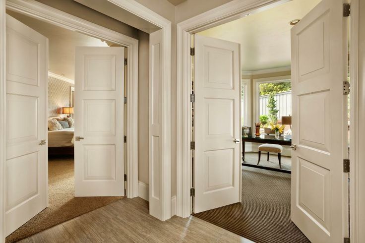 Three white interior doors open into different rooms, one with a bed, one with a desk, and one with a neutral wall.