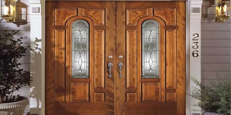 Wooden double doors with stained glass panels, framed by ornate trim. House number 236 visible on the right.