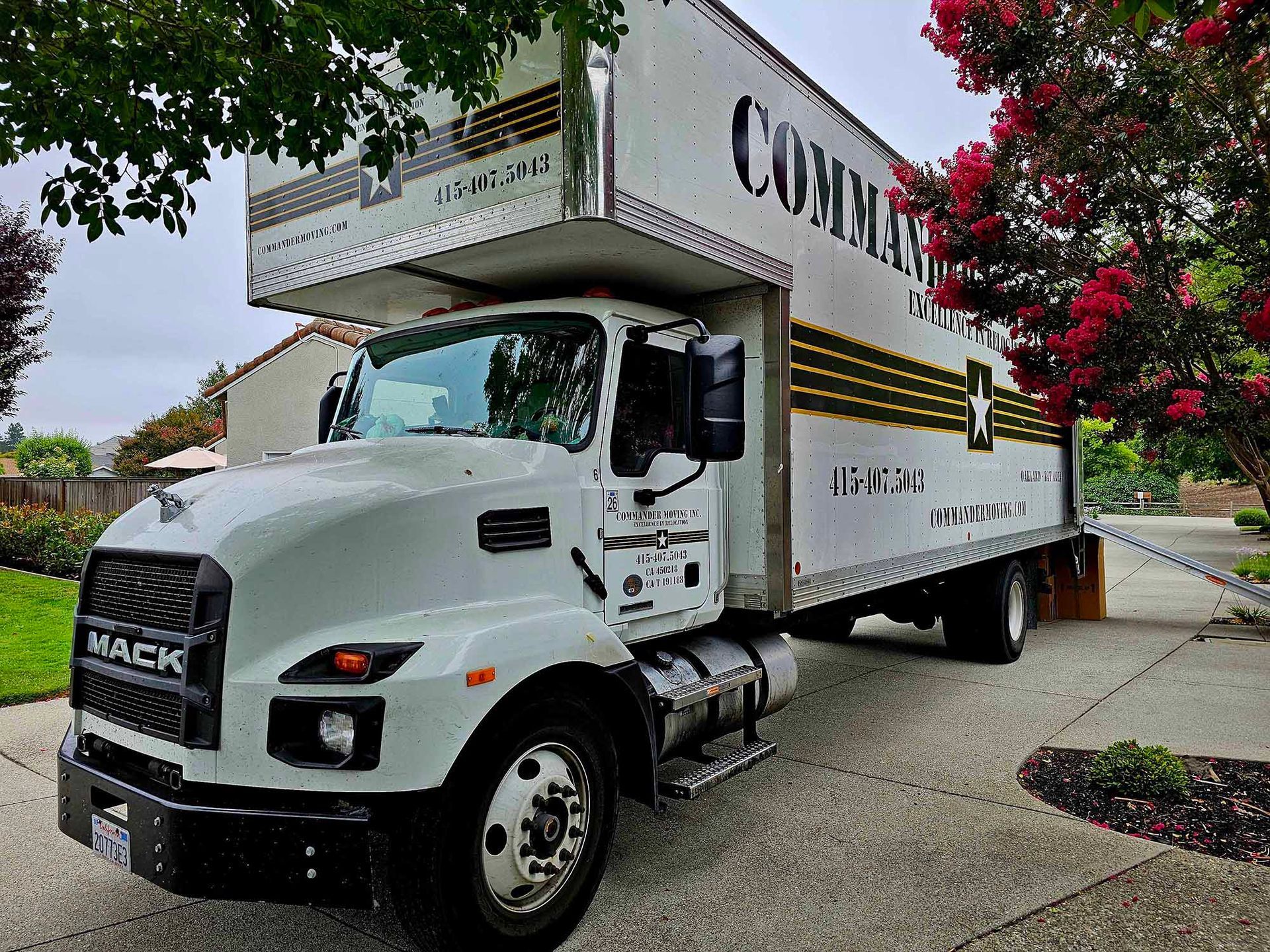 White Mack box truck parked on driveway; 