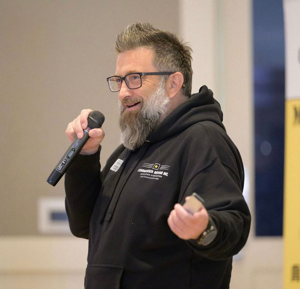 Moving truck parked in front of a house; truck is labeled