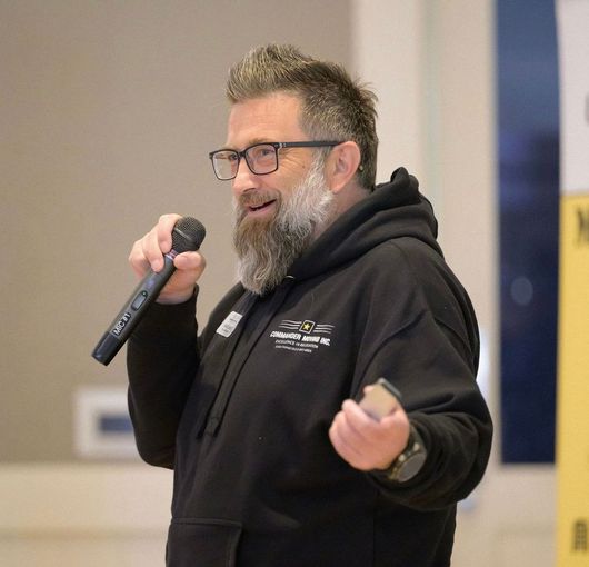 Moving truck parked in front of a house; truck is labeled 
