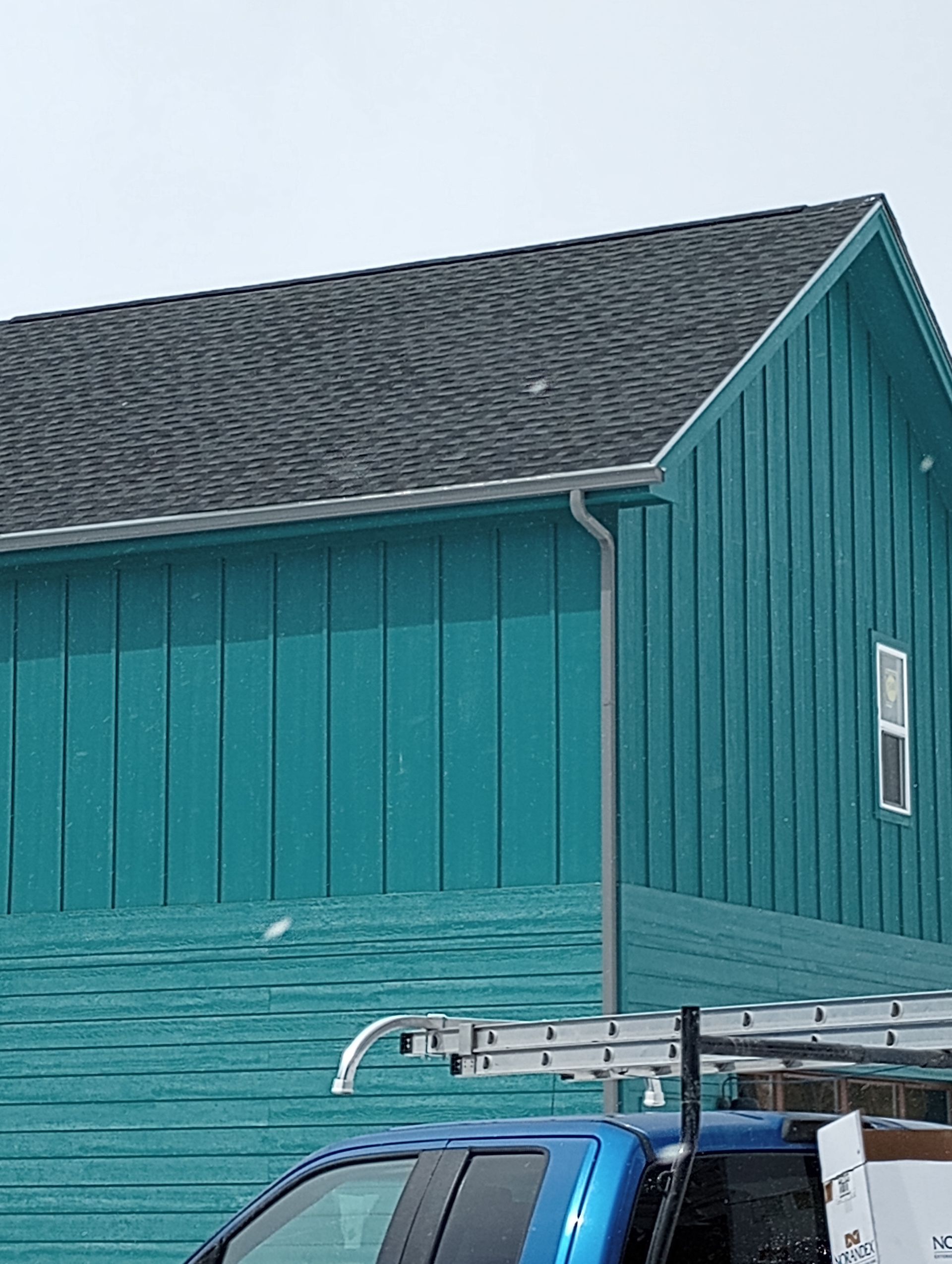 Beautiful seamless gutter of a bluish green house