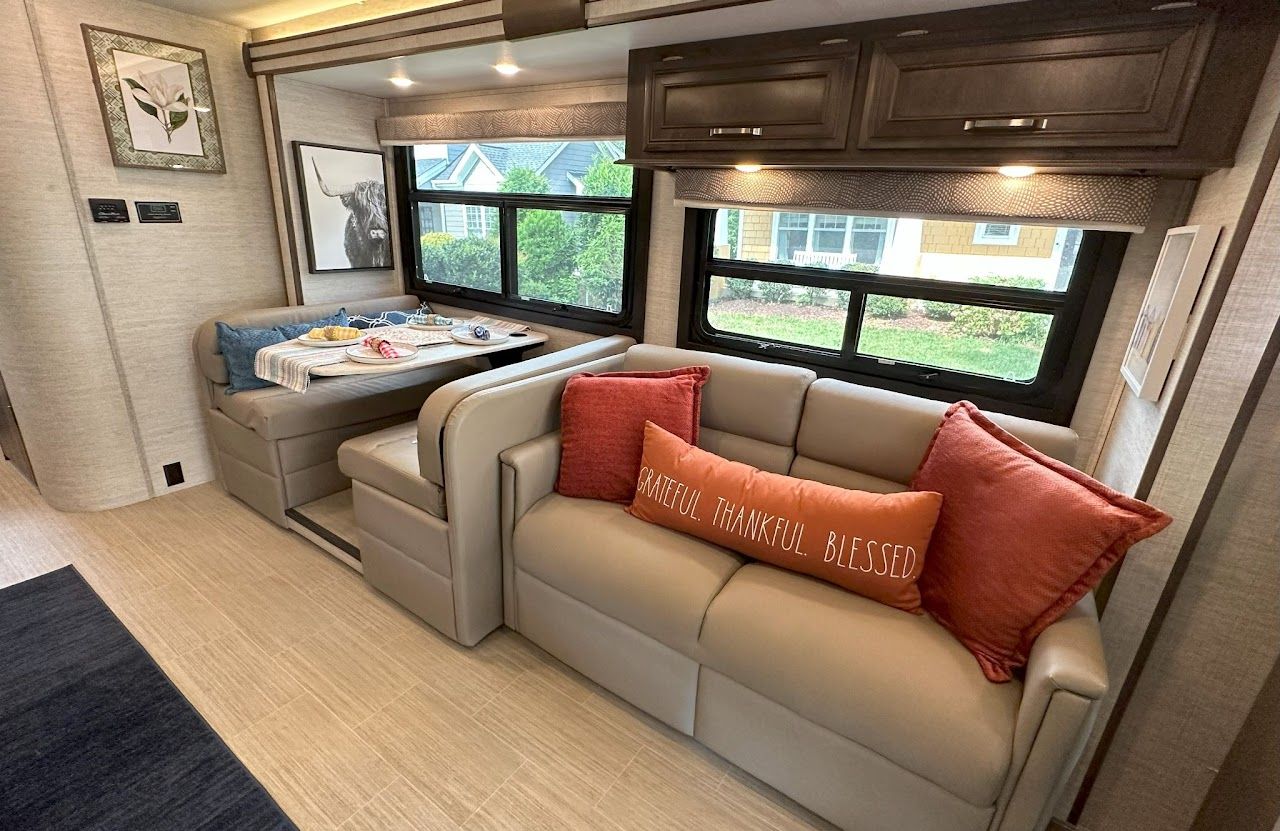 A living room in a rv with a couch and a table.