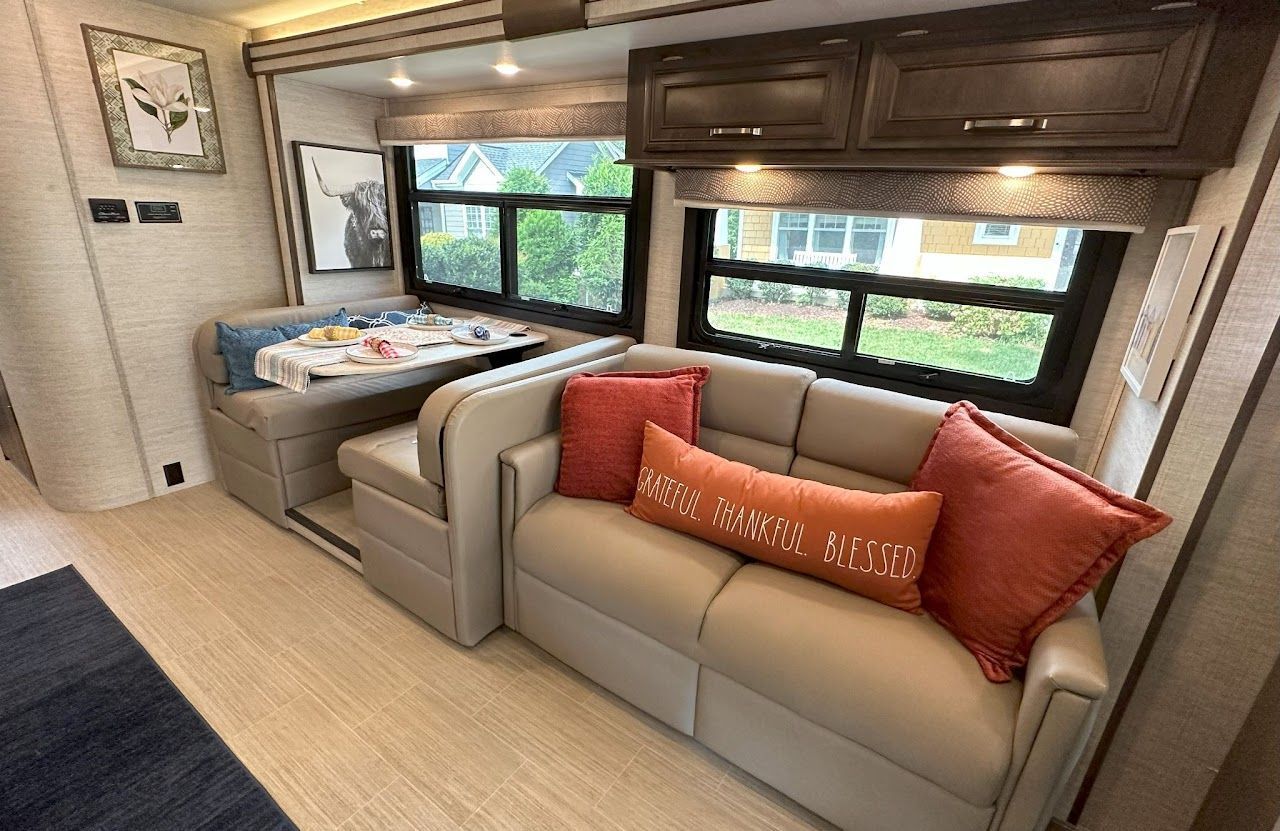 A rv with a couch and a table in it.