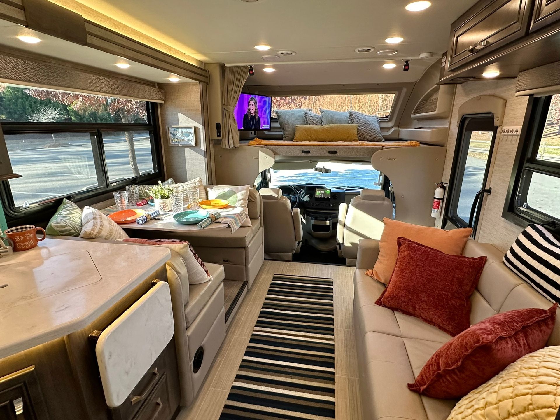 The inside of a rv with a couch and a table.