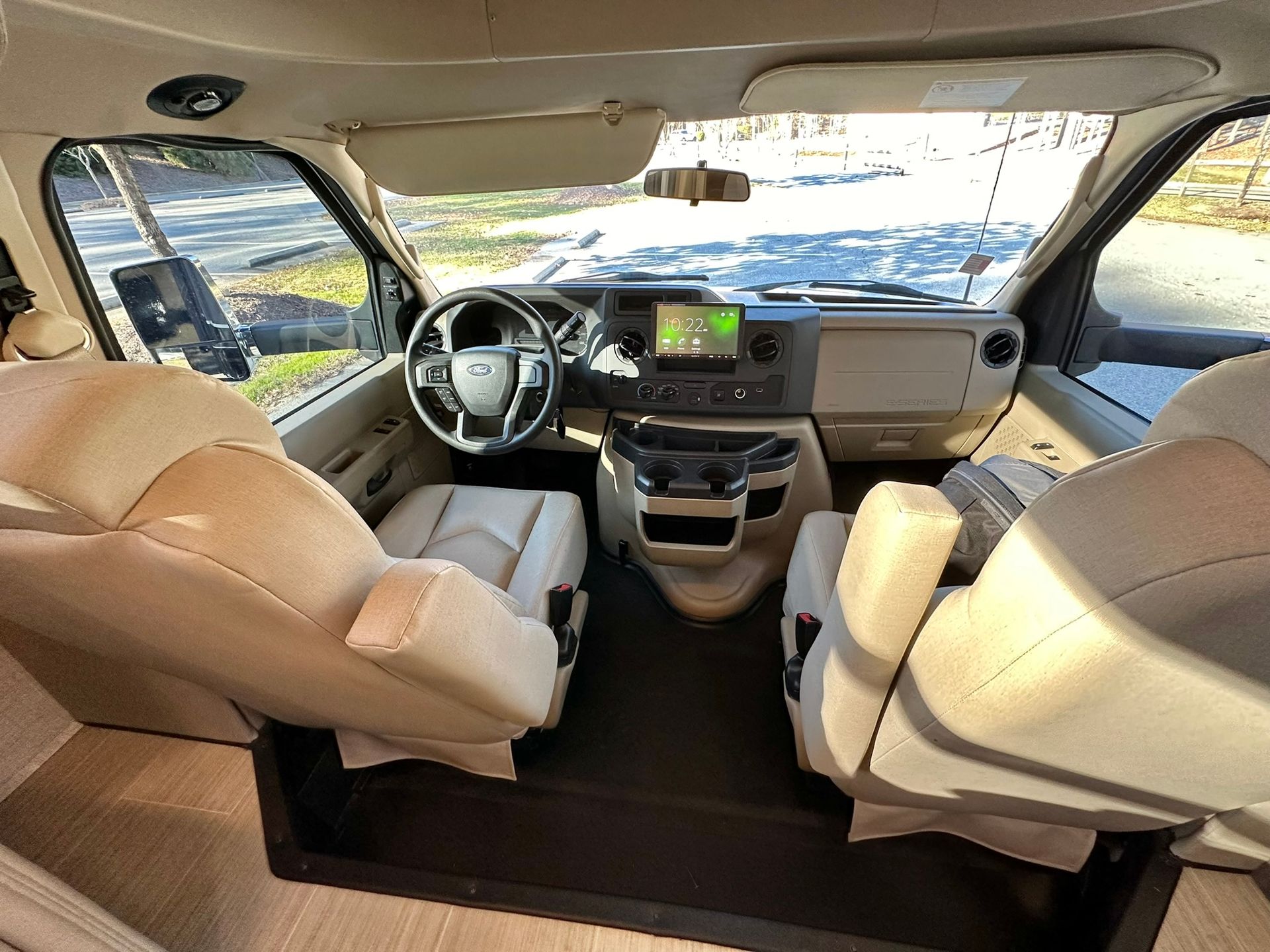 The inside of a van with a steering wheel and seats