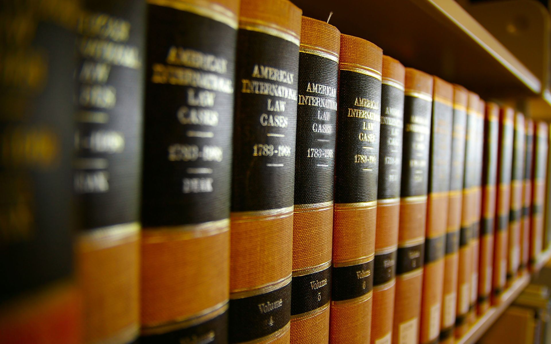 A row of law books are lined up on a shelf