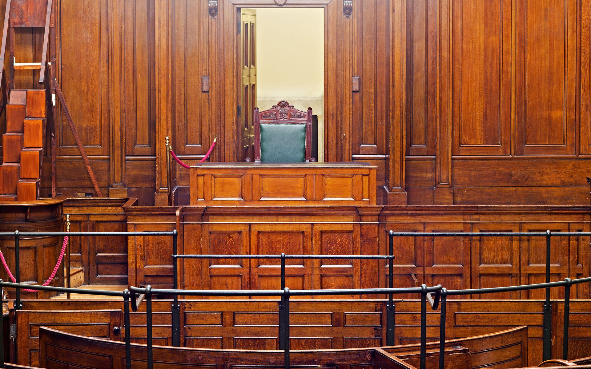 A wooden courtroom with a judge 's chair in the middle