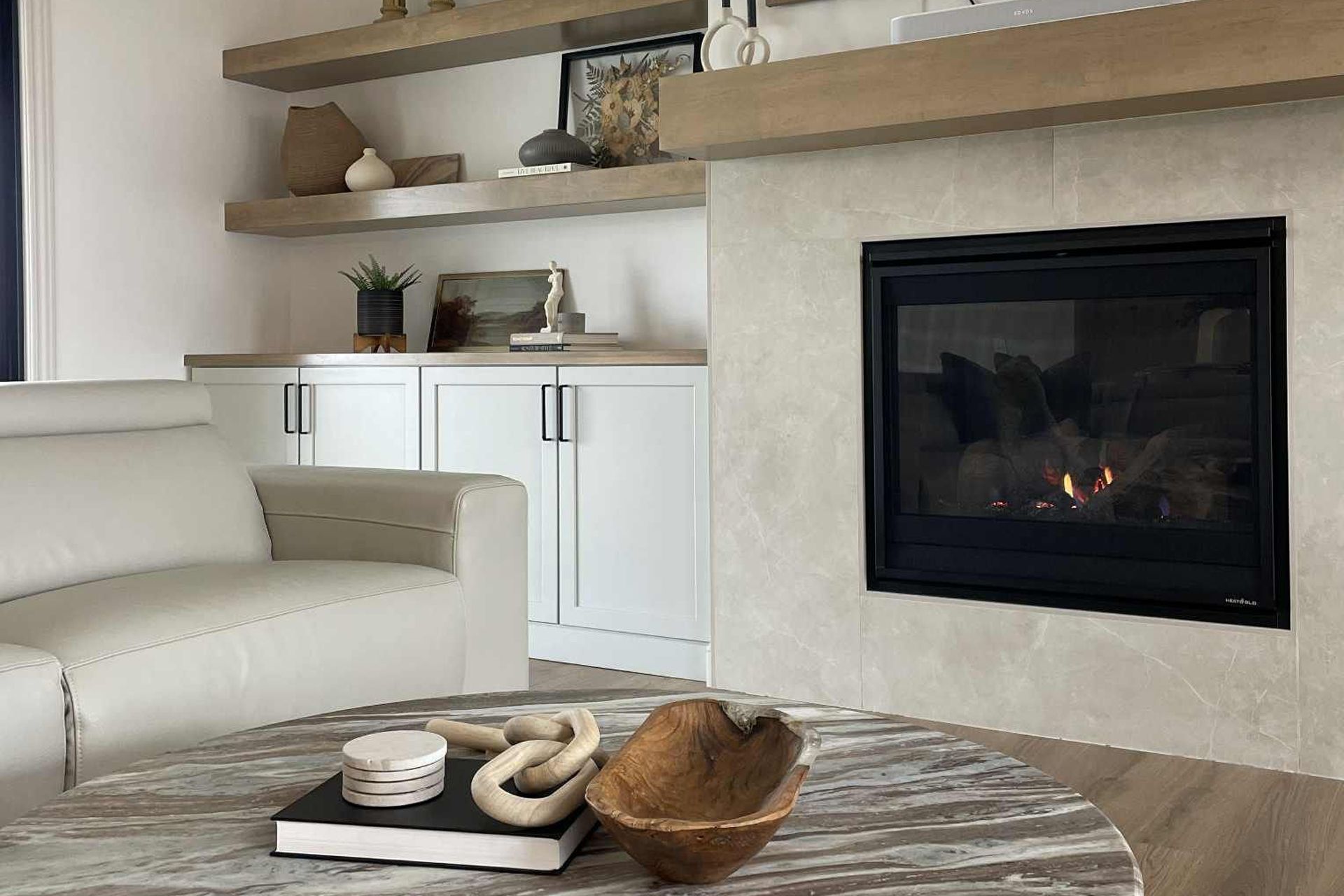 Living room with fireplace, white sofa, and round coffee table 