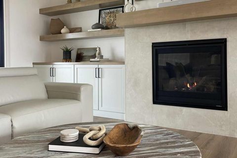 Living room with fireplace, white sofa, and round coffee table