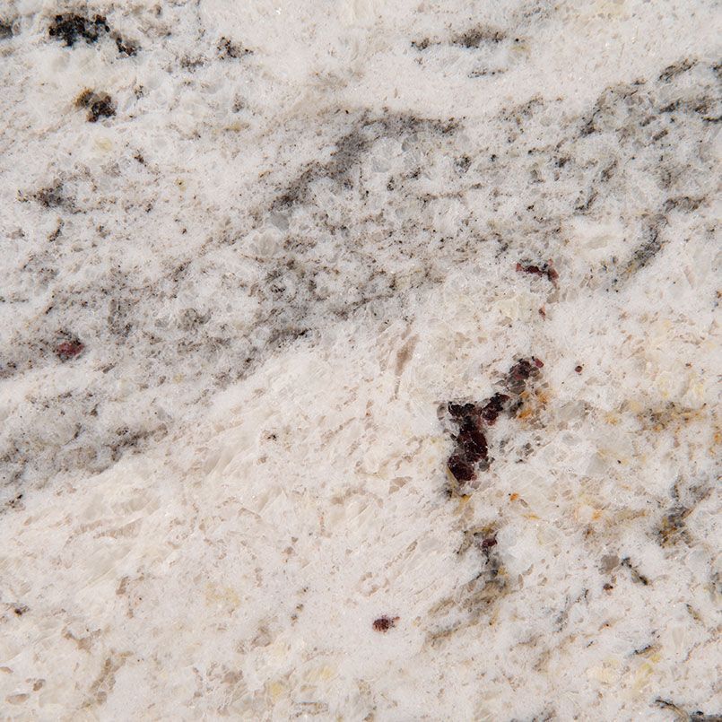 Close-up of granite countertop with white, gray, and brown speckled patterns.
