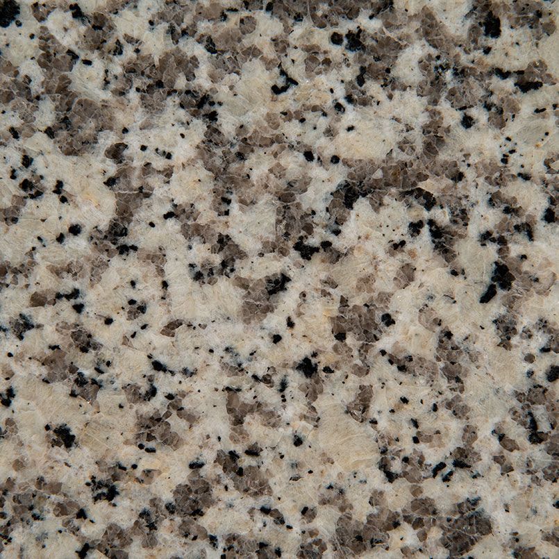 Close-up of granite countertop with tan, gray, and black speckles.