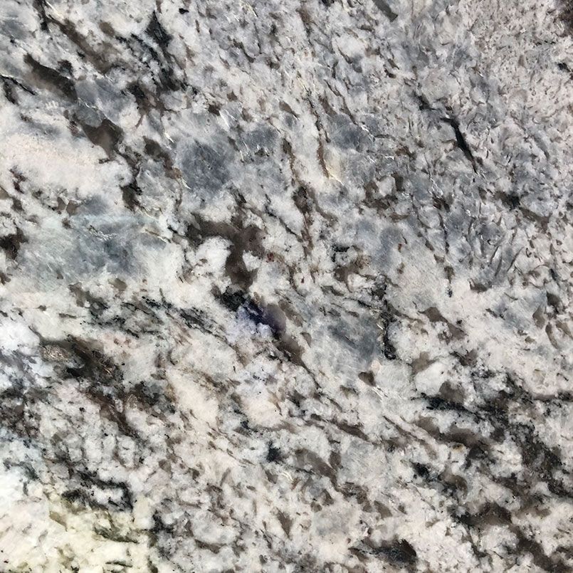 Close-up of granite countertop. White, gray, and black mottled patterns.