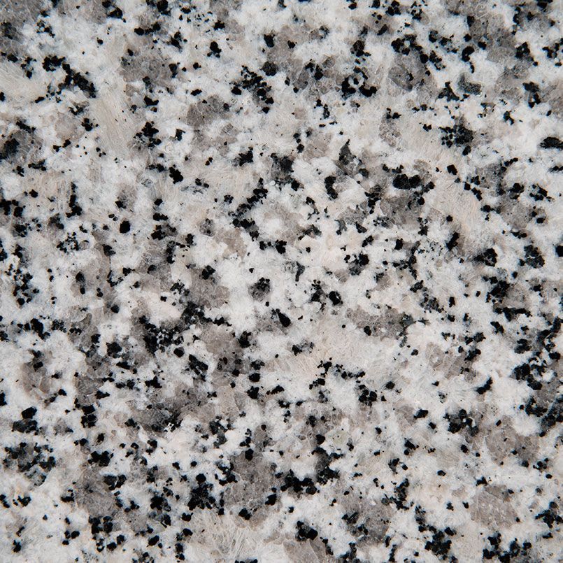 Close-up of granite surface, showing gray, white, and black speckled pattern.