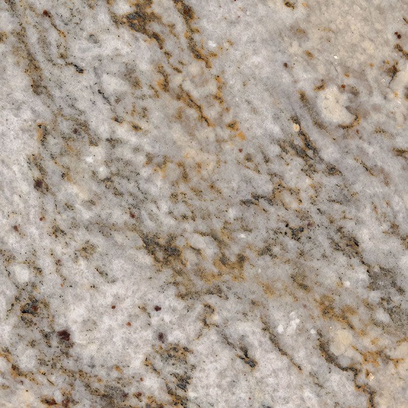 Close-up of granite countertop with a white and tan swirl pattern with brown veins.