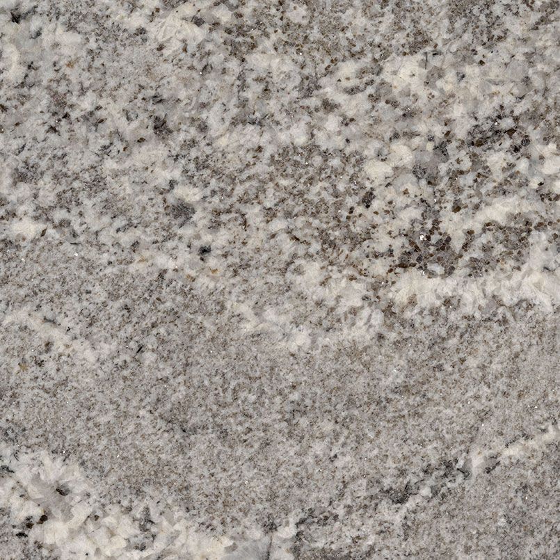 Close-up of a white granite countertop with gray and black speckles and swirls.