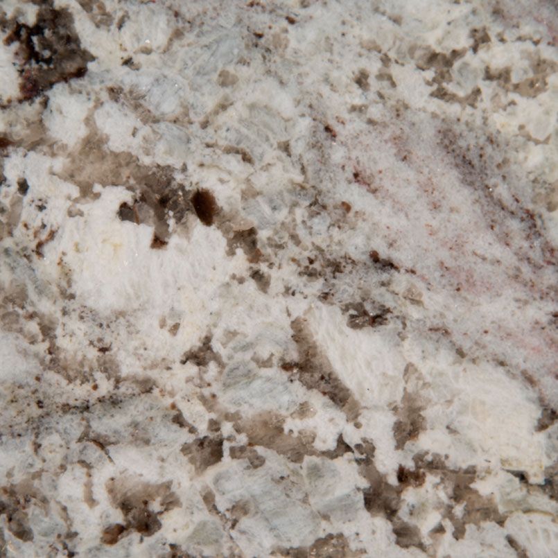 Close-up of a white and gray granite countertop with dark brown and pink veining.