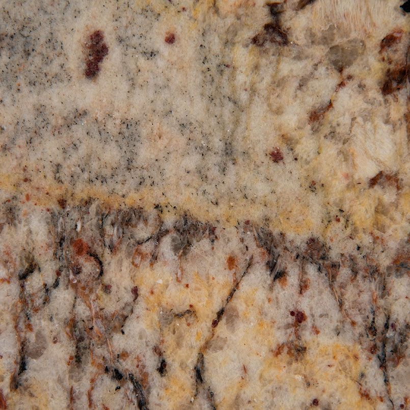 Close-up of a granite surface with beige, brown, and dark speckled patterns.