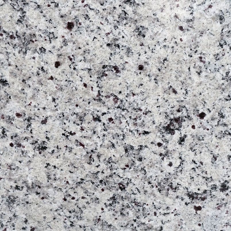 White and gray granite surface with scattered dark flecks.