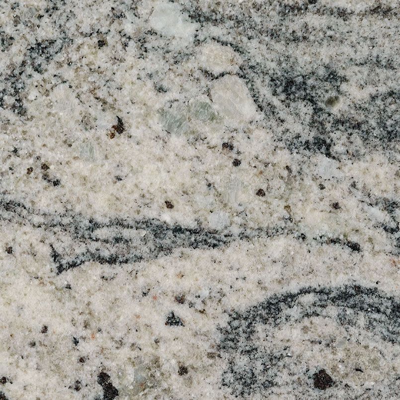 Close-up of granite countertop. White base with dark gray and black veining, speckled with black.
